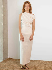 Woman wearing the banana and pineapple fibre drape neck top styled in a minimal outfit