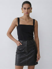 Model wearing the brown Donna faux leather skirt with vintage-inspired topstitching and structured fit against a white background