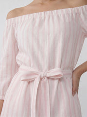 Close-up of the off shoulder playsuit showing feminine neckline and bare shoulder detail