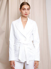 Model wearing the white Agnes Jacket with an oversized tailored silhouette by Noumenon
