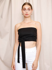 Model wearing the black Bella Tube Top with a strapless fitted silhouette by Noumenon