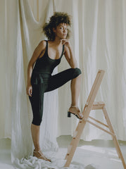 Side view of the catsuit showing body-contouring fitted silhouette and stretch fabric