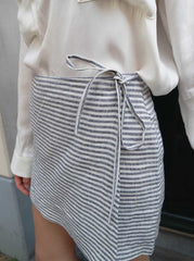 Model wearing the linen skort showing the skirt-like front panel design by Noumenon