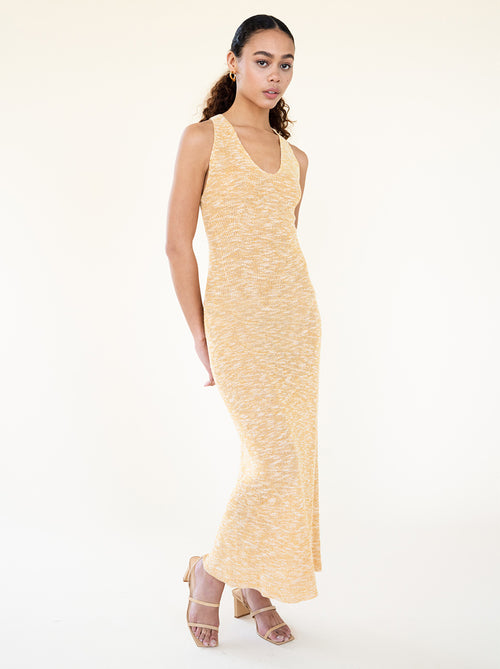 Woman wearing the Naomi Dress styled in a minimal indoor setting showing its fluid silhouette by Sisterhood