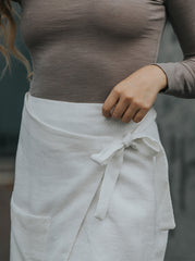 Woman wearing the wrapped pocket skirt styled as an effortless eco-chic summer outfit